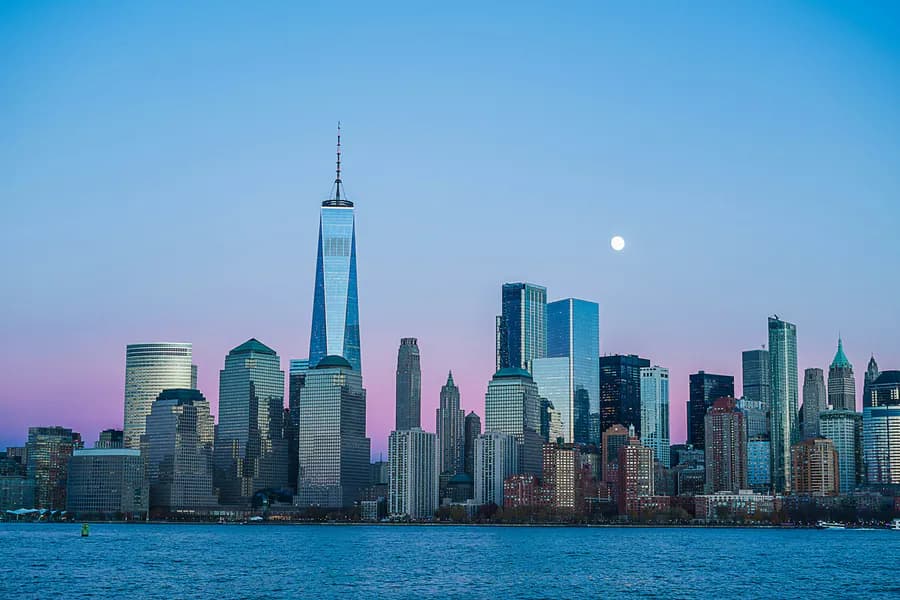 Urban skyline at night—density, neighborhoods, and local market presence.